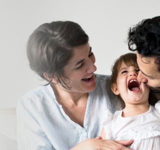 happy-parents-laughing-together-with-daughter.jpg